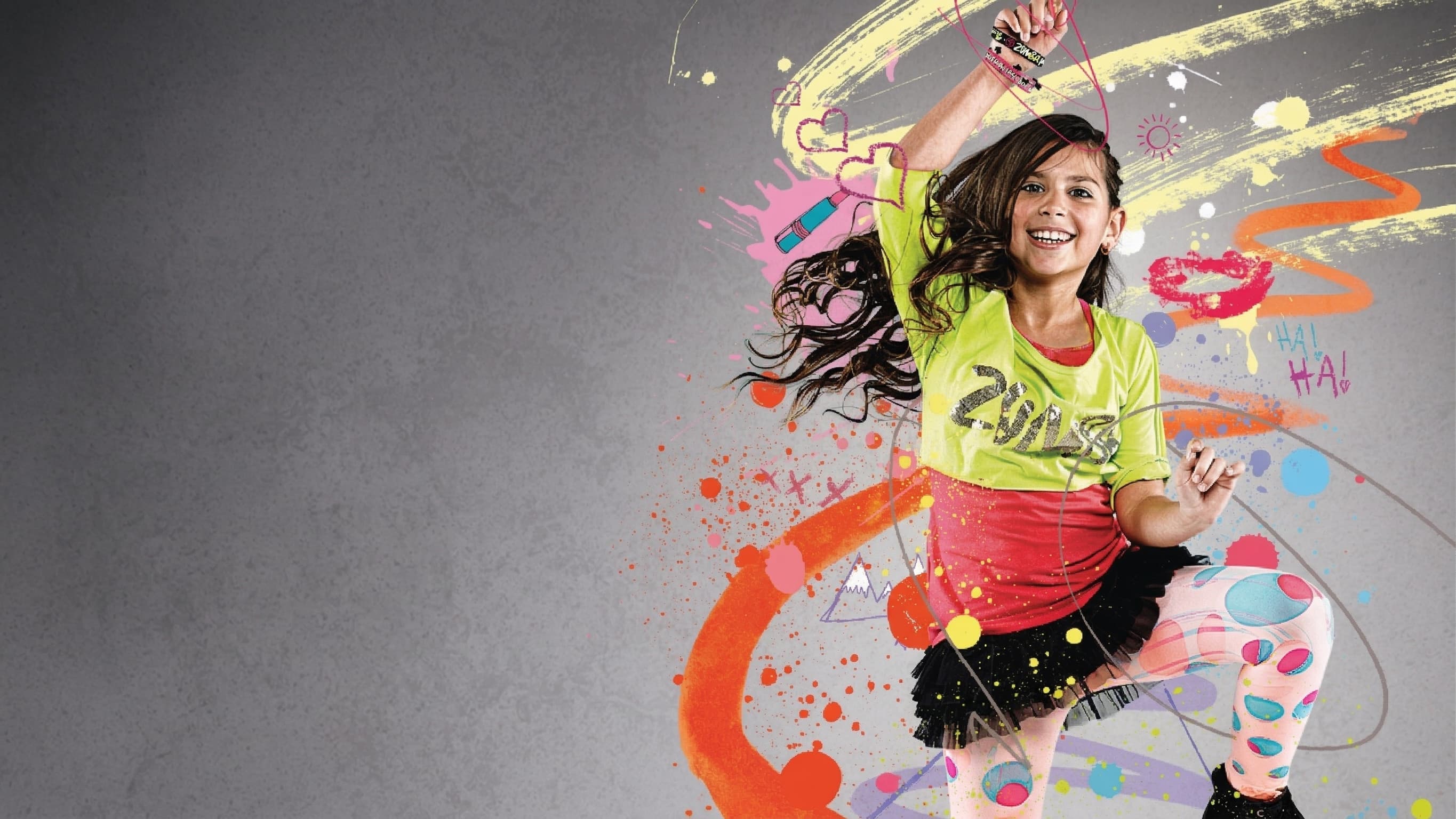 Zumba Kids promotional image — young dancer mid-movement with vibrant paint splash graphics and 'All We Need Is A Beat' tagline