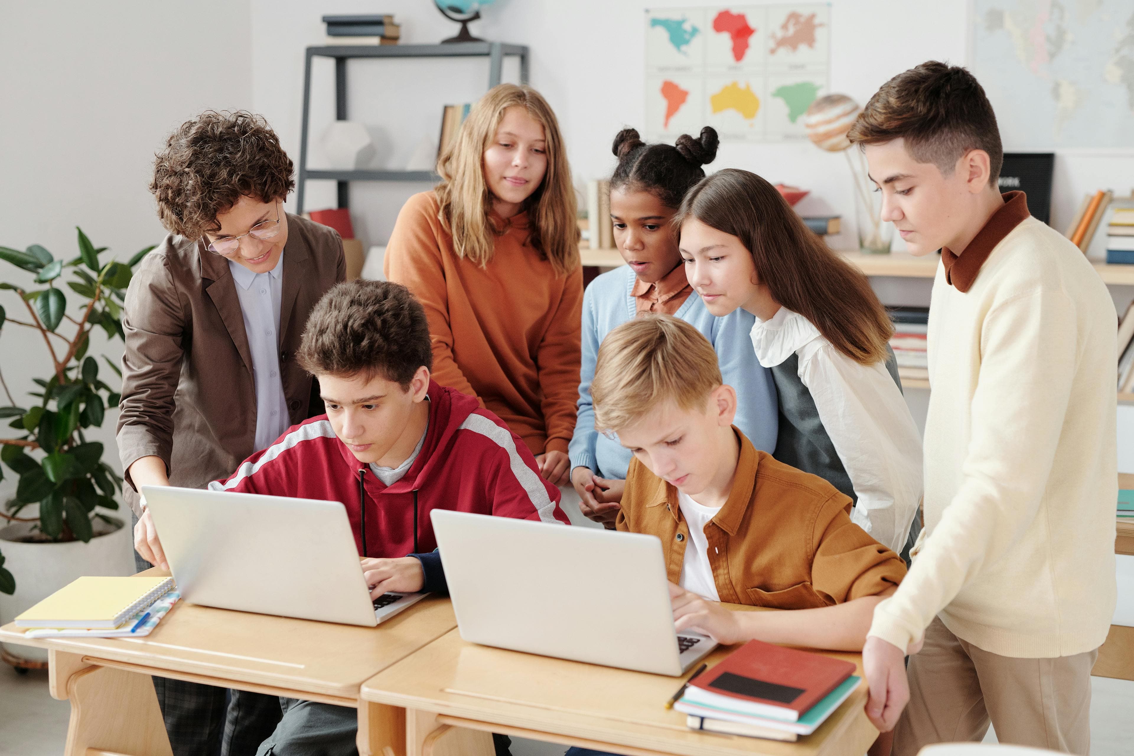 Students working with coding and robotics equipment in a classroom