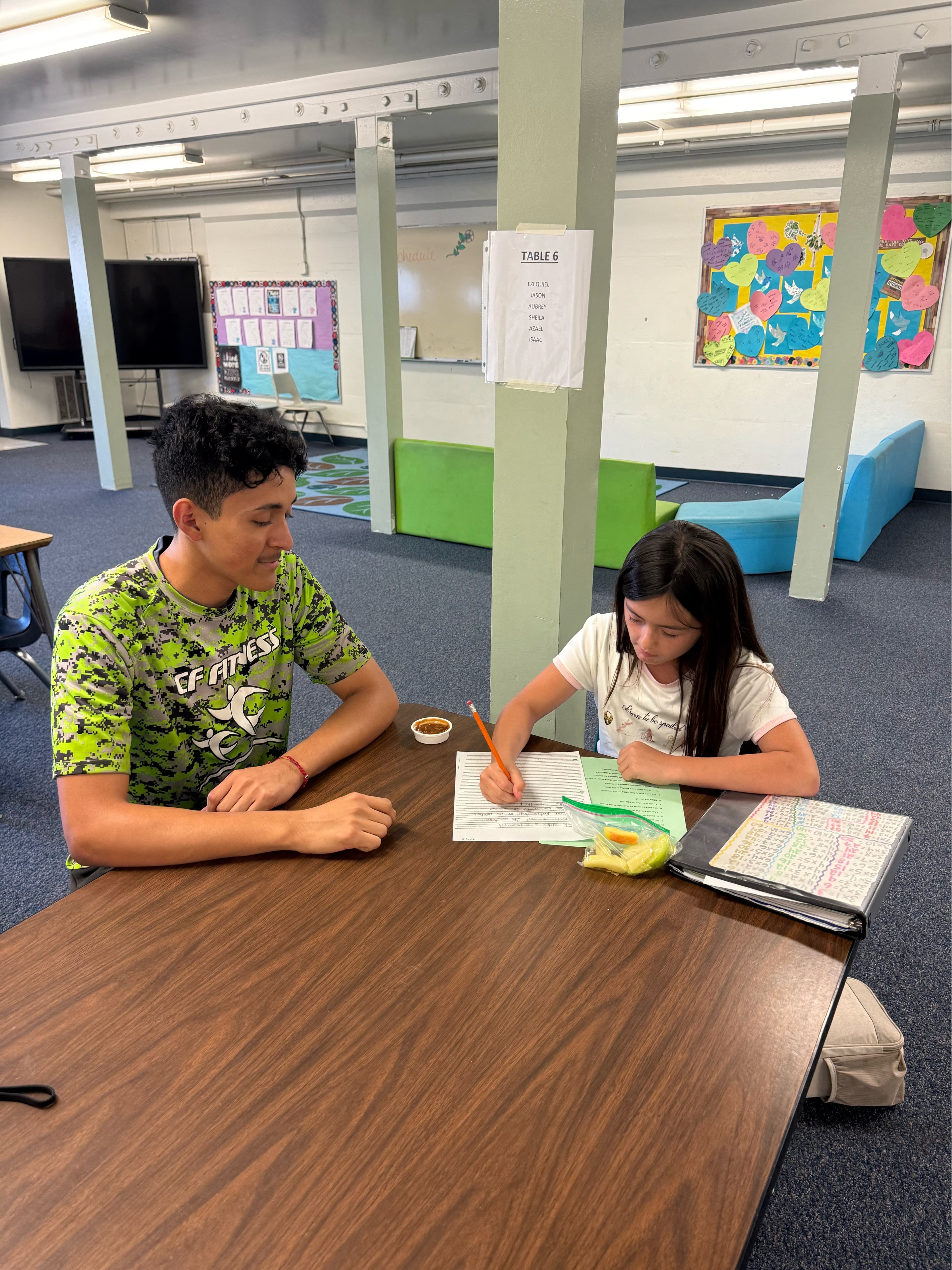 CF Fitness staff member helping student with homework and academic support
